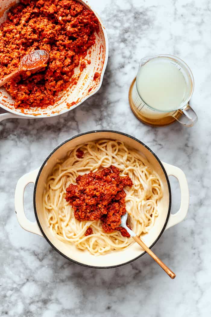 Adding meat sauce to cooked spaghetti