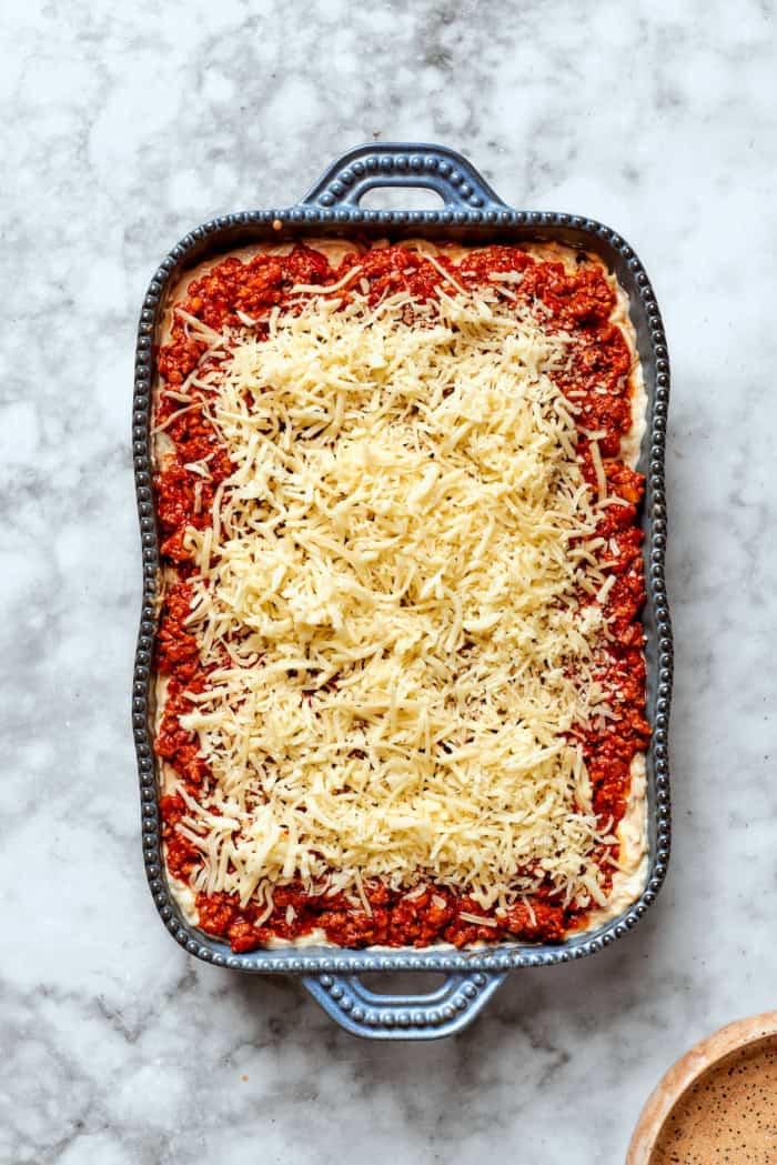 Overhead view of spaghetti casserole in baking dish before baking