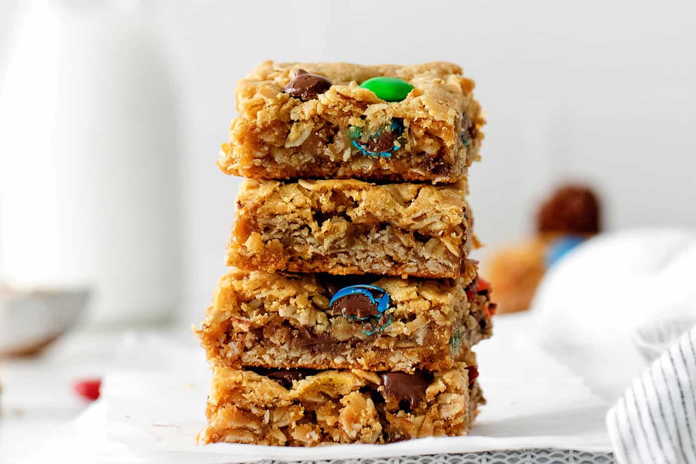 Four monster cookie bars stacked on each other