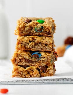 Four monster cookie bars stacked on each other