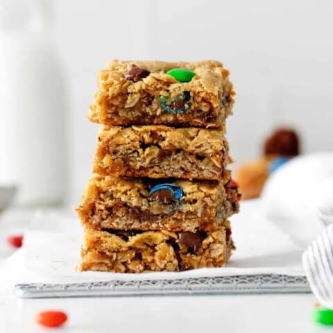 Four monster cookie bars stacked on each other