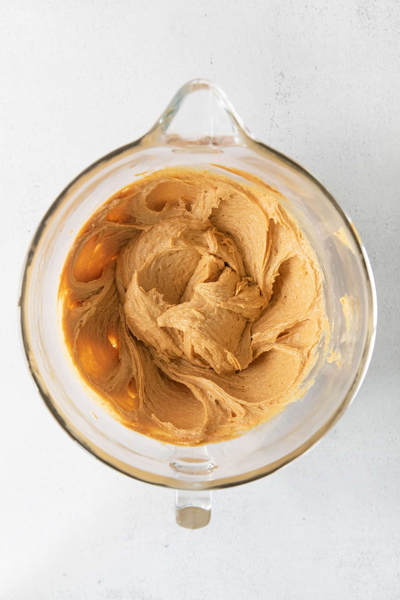 Wet cookie dough ingredients in a mixing bowl