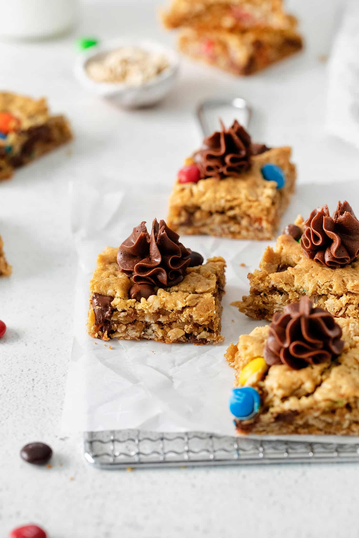 Angled views of monster cookie bars topped with icing