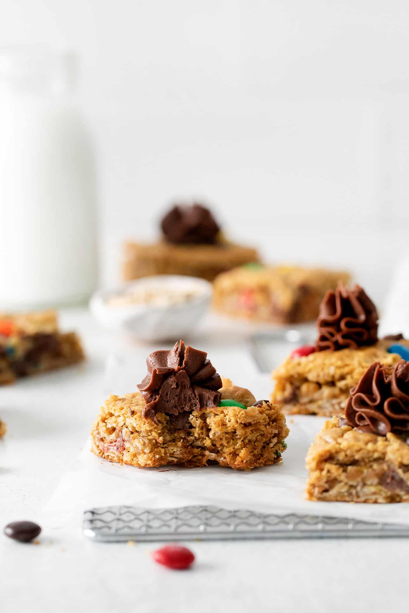 Angled view of monster cookie bars with frosting