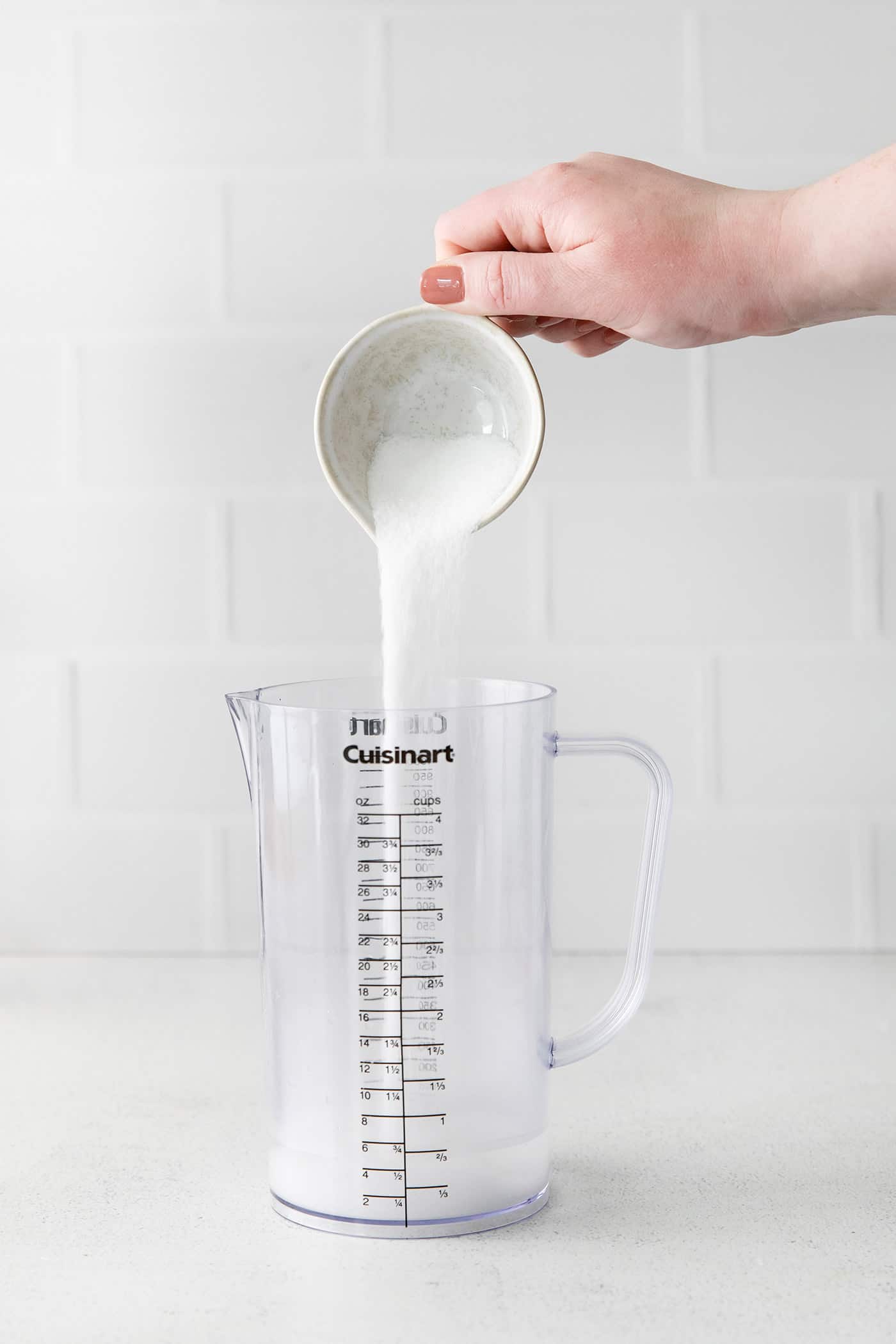 Sugar being added to a pitcher