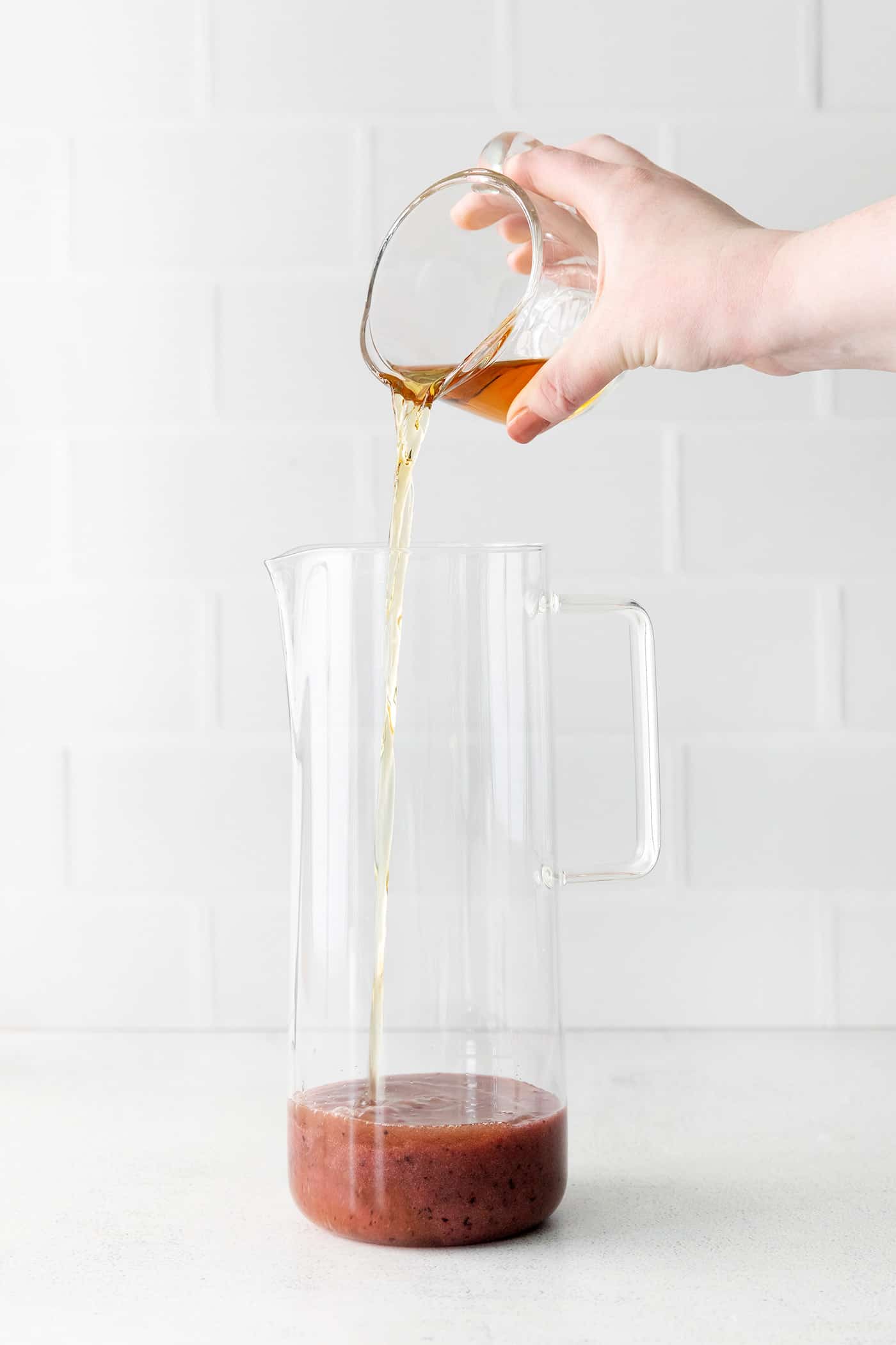 Bourbon being added to a pitcher