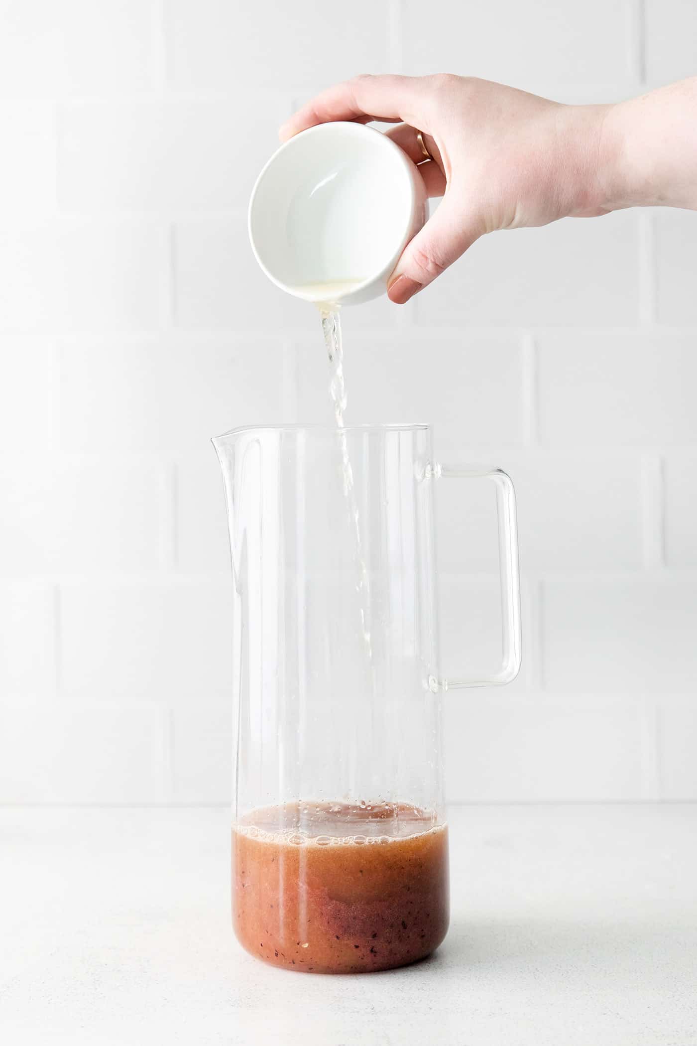 Lemon juice being added to a pitcher