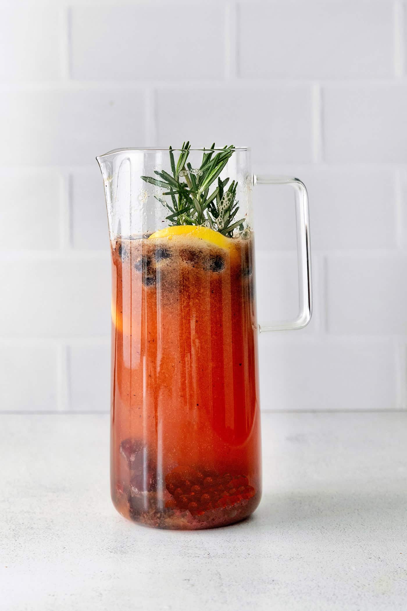 A pitcher of fruity sangria with bourbon
