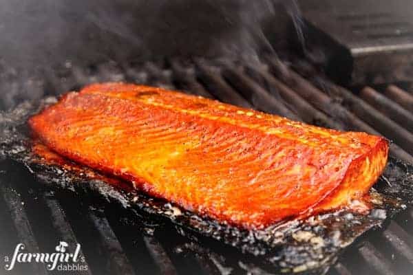 A salmon fillet cooking on the grill