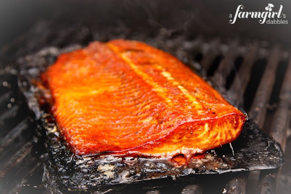 a piece of salmon cooking on a grill 