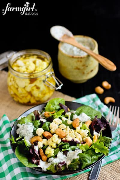 fresh salad, a jar of pickled cauliflower, and summer dressing