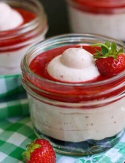Strawberry Fluff dessert in a jar topped with Fresh Strawberry Sauce