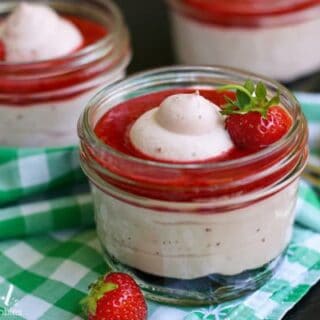 Strawberry Fluff dessert in a jar topped with Fresh Strawberry Sauce