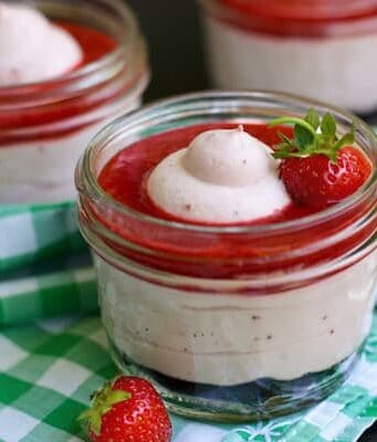 Strawberry Fluff dessert in a jar topped with Fresh Strawberry Sauce