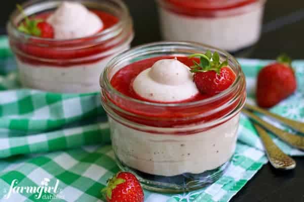 Strawberry Fluff dessert in a jar topped with Fresh Strawberry Sauce