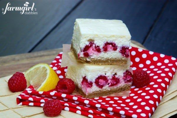 a stack of lemon and raspberry cheesecake bars