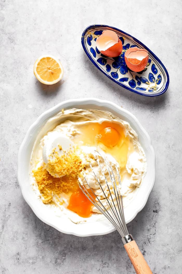 Whisking egg and lemon zest into cream cheese mixture