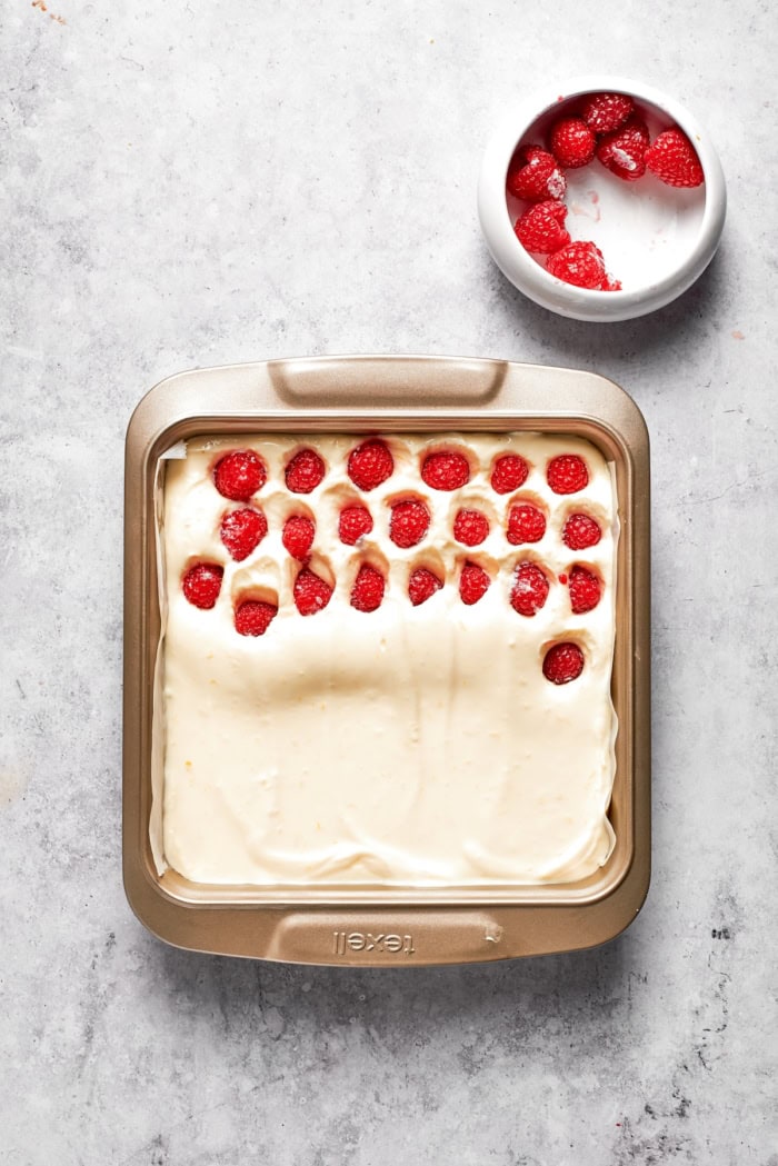 Adding raspberries to lemon cheesecake bars