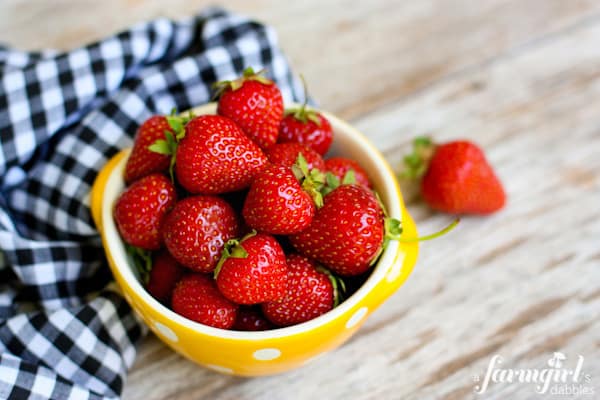 a yellow bowl of strawberries