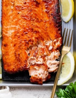 Overhead view of sweet and smoky salmon with corner flaked to show texture