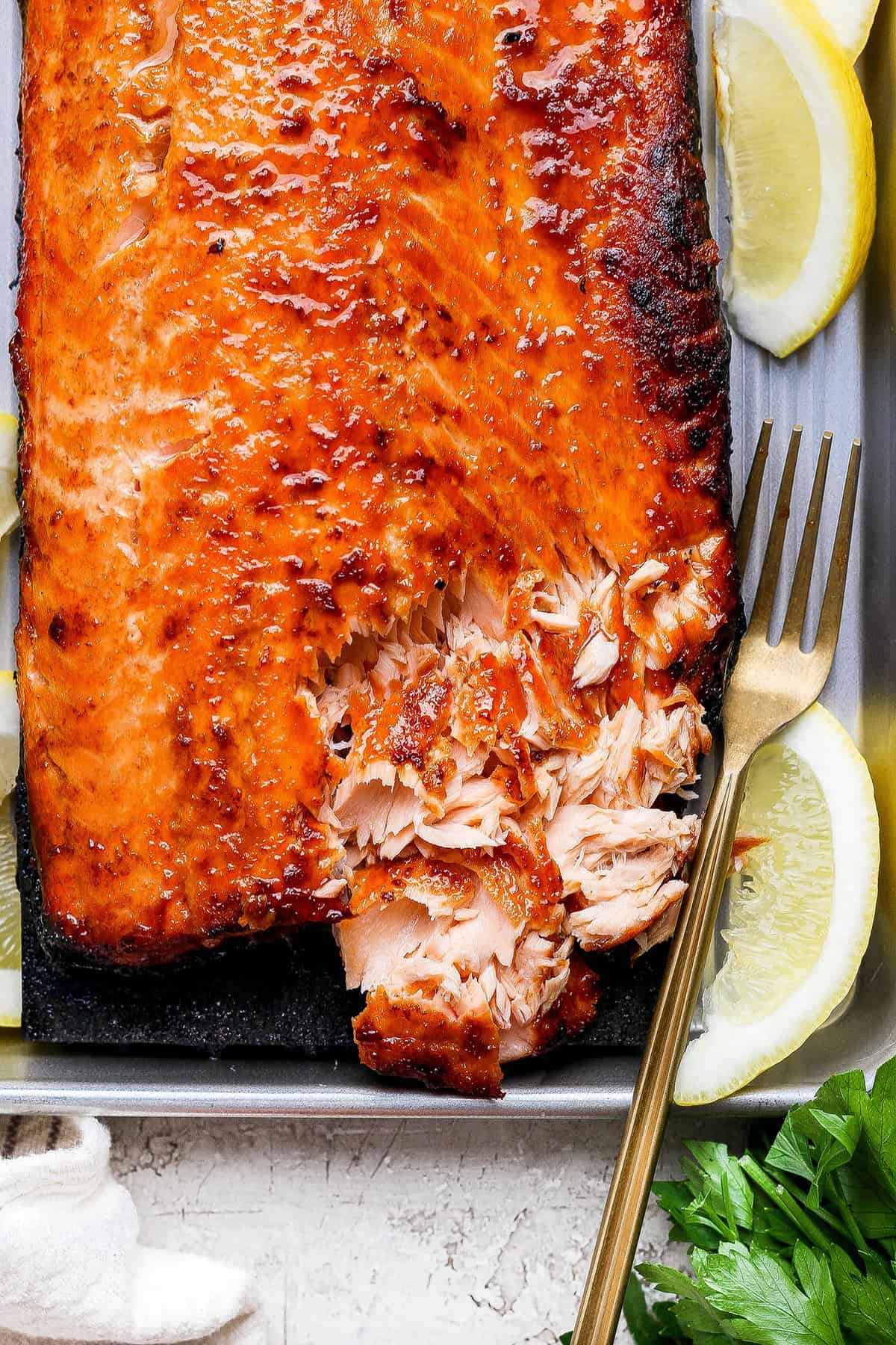 Overhead view of sweet and smoky salmon with corner flaked to show texture