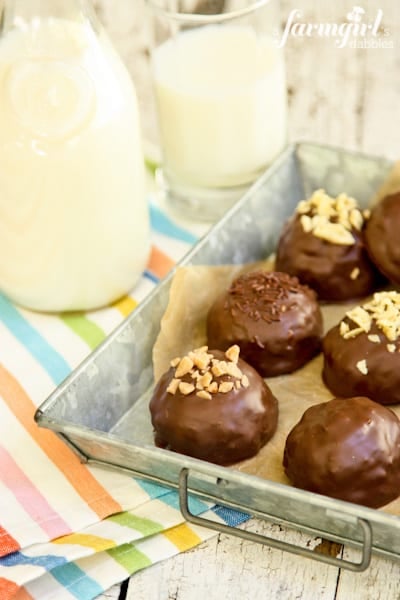 a glass and pitcher of milk with Peanut Butter Bonbons