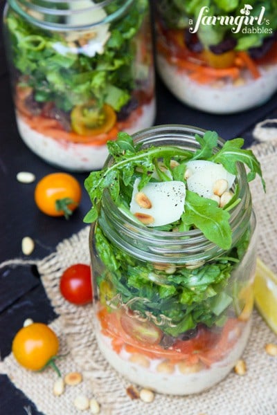 three mason jars of Chopped Salad with caesar dressing