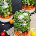 Jars of lettuce, carrots, and tomatoes