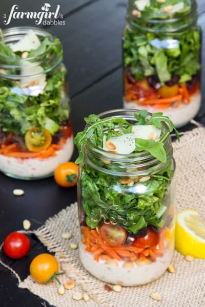 jars of lettuce, carrots, and tomatoes