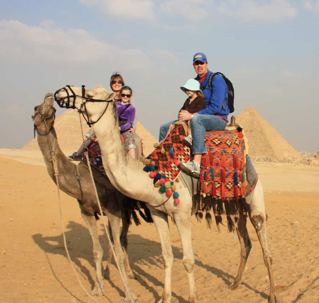 a family riding camels in Egypt