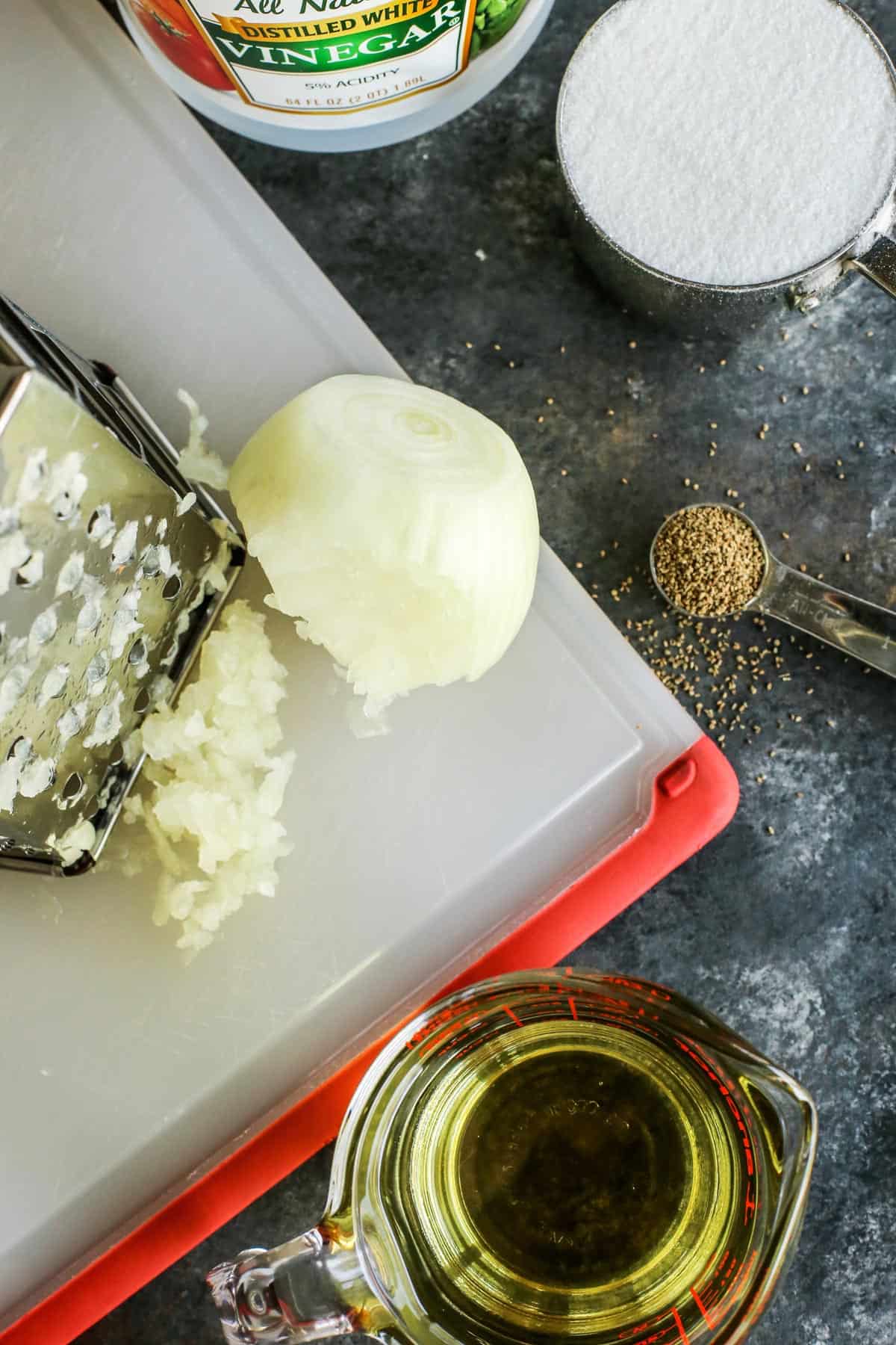 vinegar, sugar, celery seeds, oil, and a shredded onion