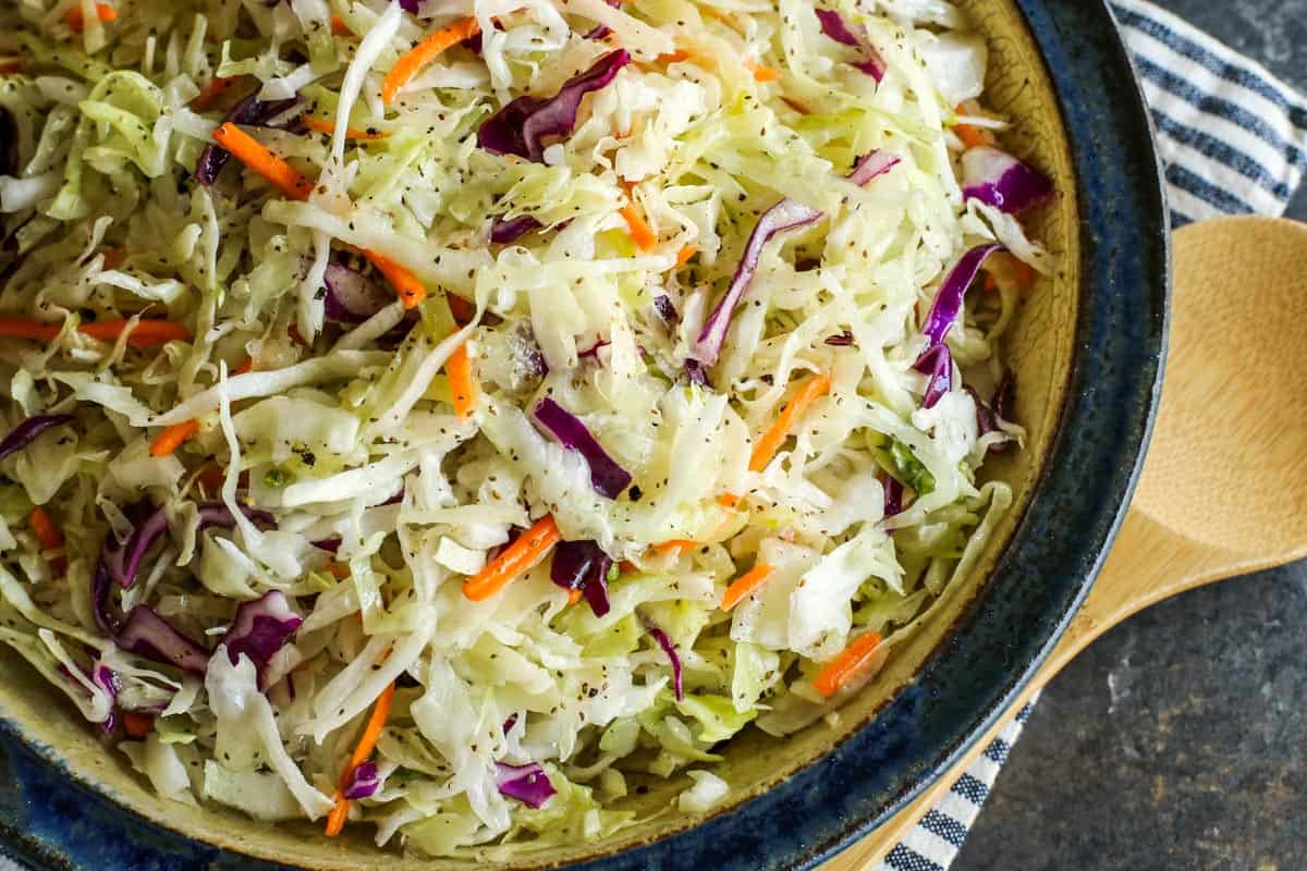 a pottery bowl of coleslaw salad