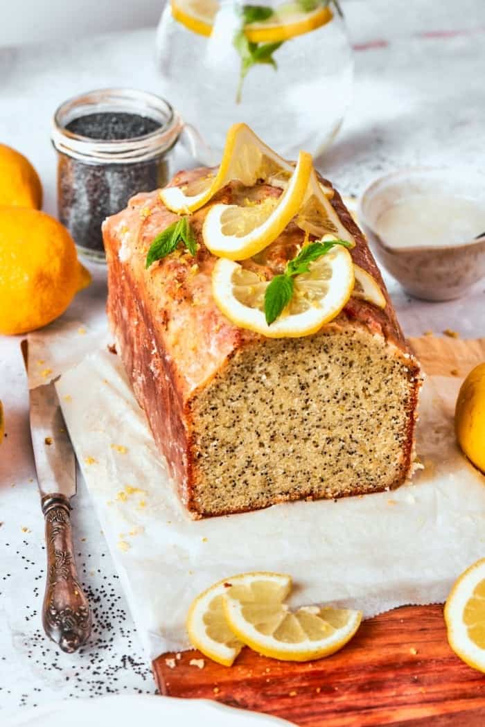 Loaf of almond lemon poppy seed bread, cut to show moist crumb.