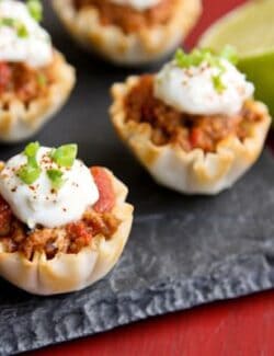 turkey taco cups topped with a lime sour cream