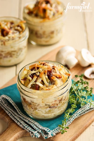 Individual glass jars of Potato Gratins topped with Bacon and Mushrooms