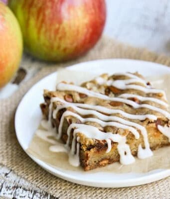 a slice of an Apple Bar with whole, fresh apples