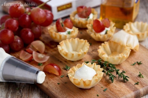 whipped goat cheese being piped into phyllo shells