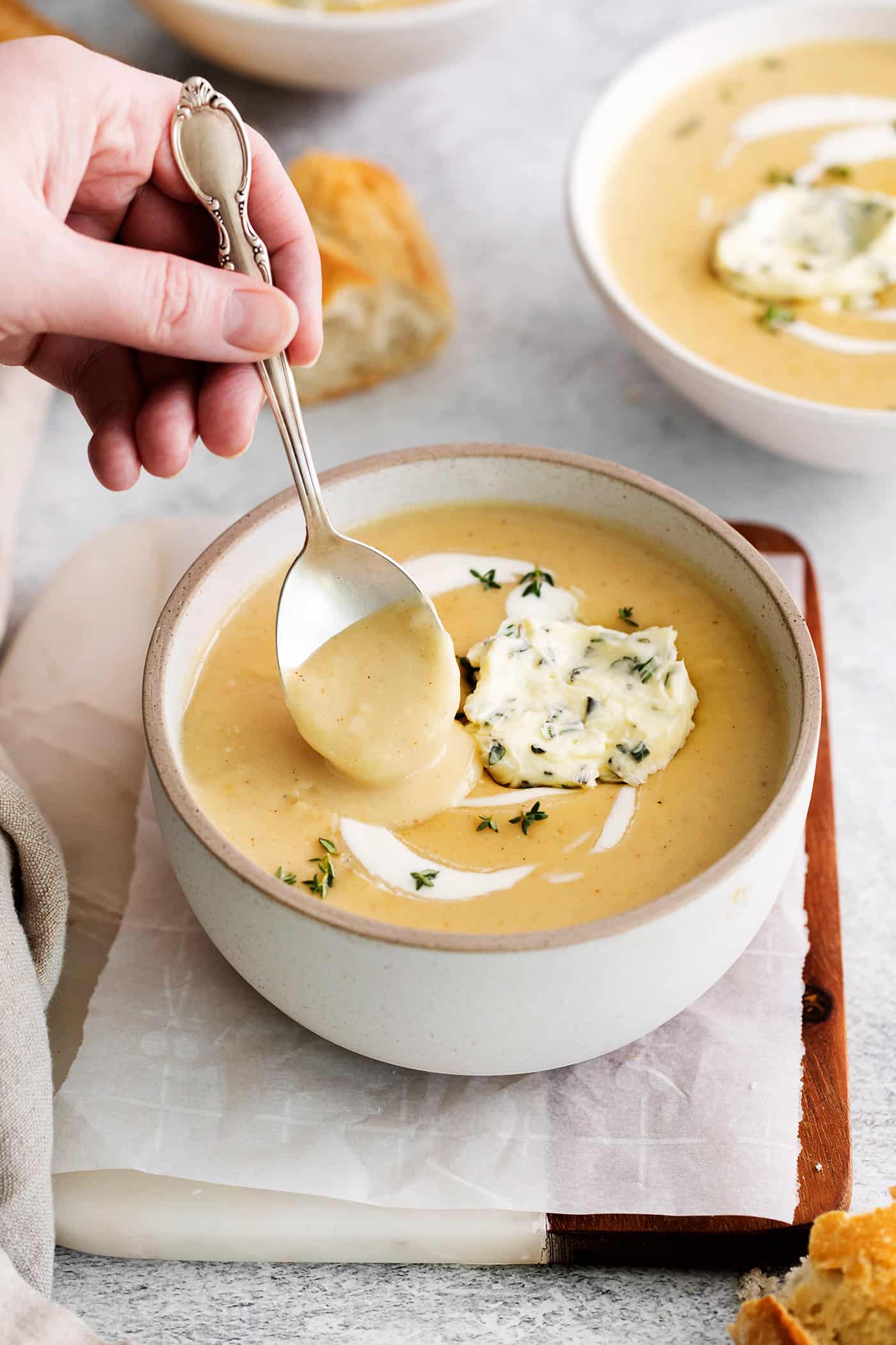 A spoon stirring a bowl of potato soup