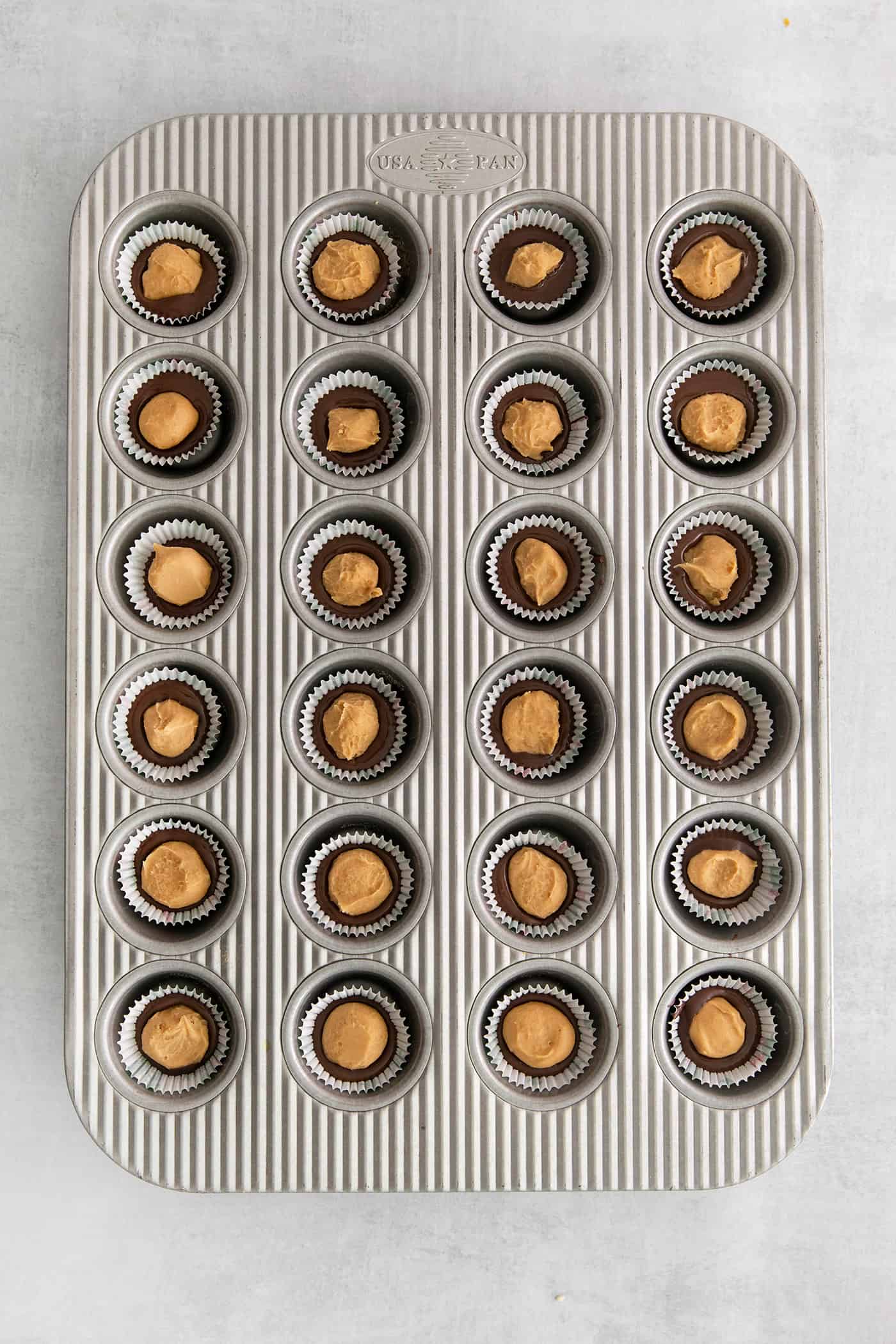 Overhead view of peanut butter balls in mini muffin tins