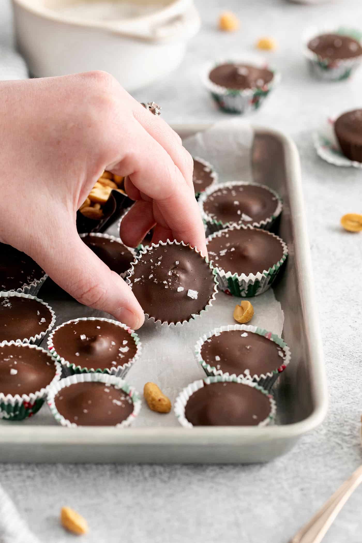 A hand holding a peanut butter cup