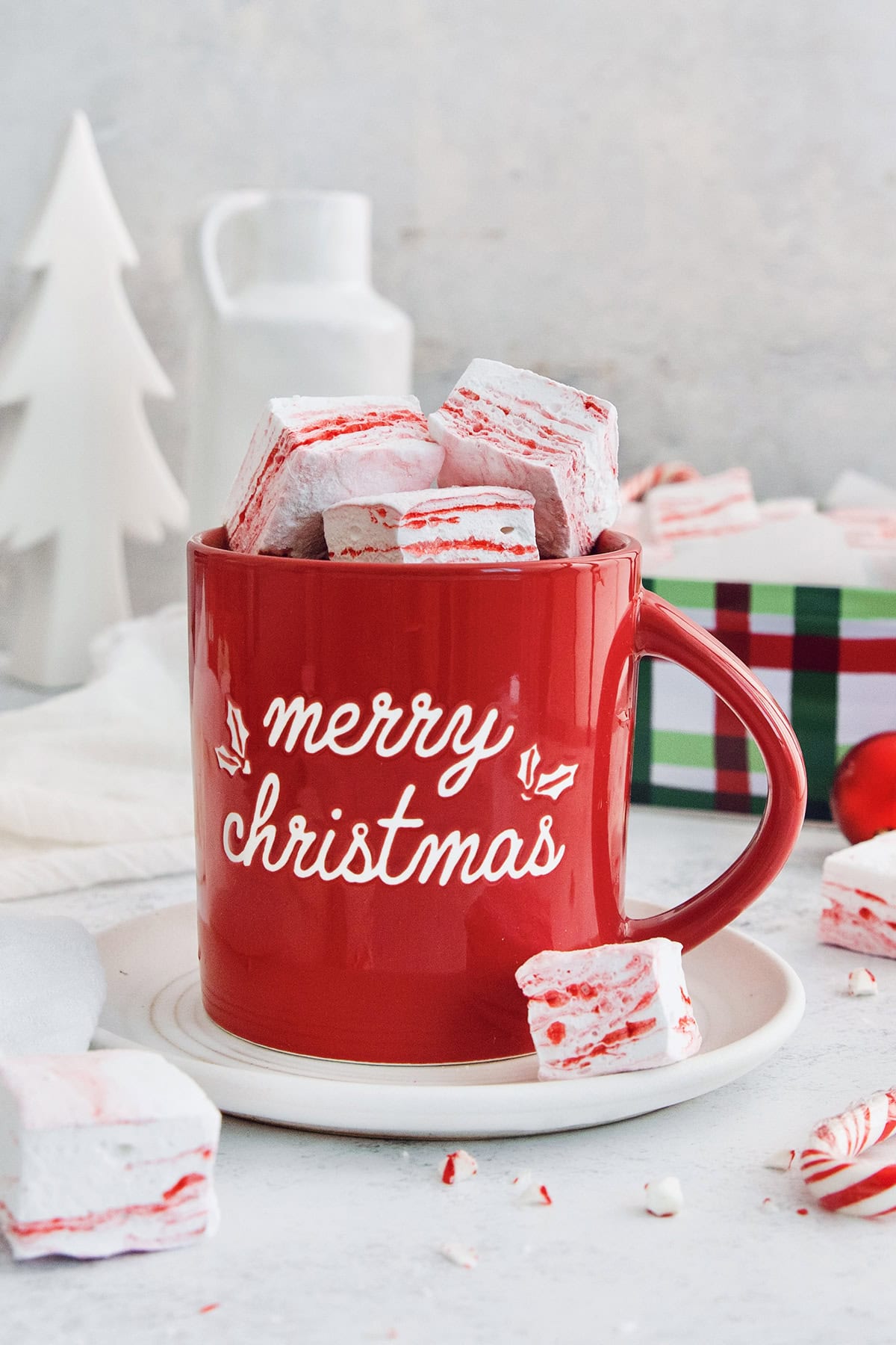 Peppermint marshmallows piled into mug of hot chocolate.