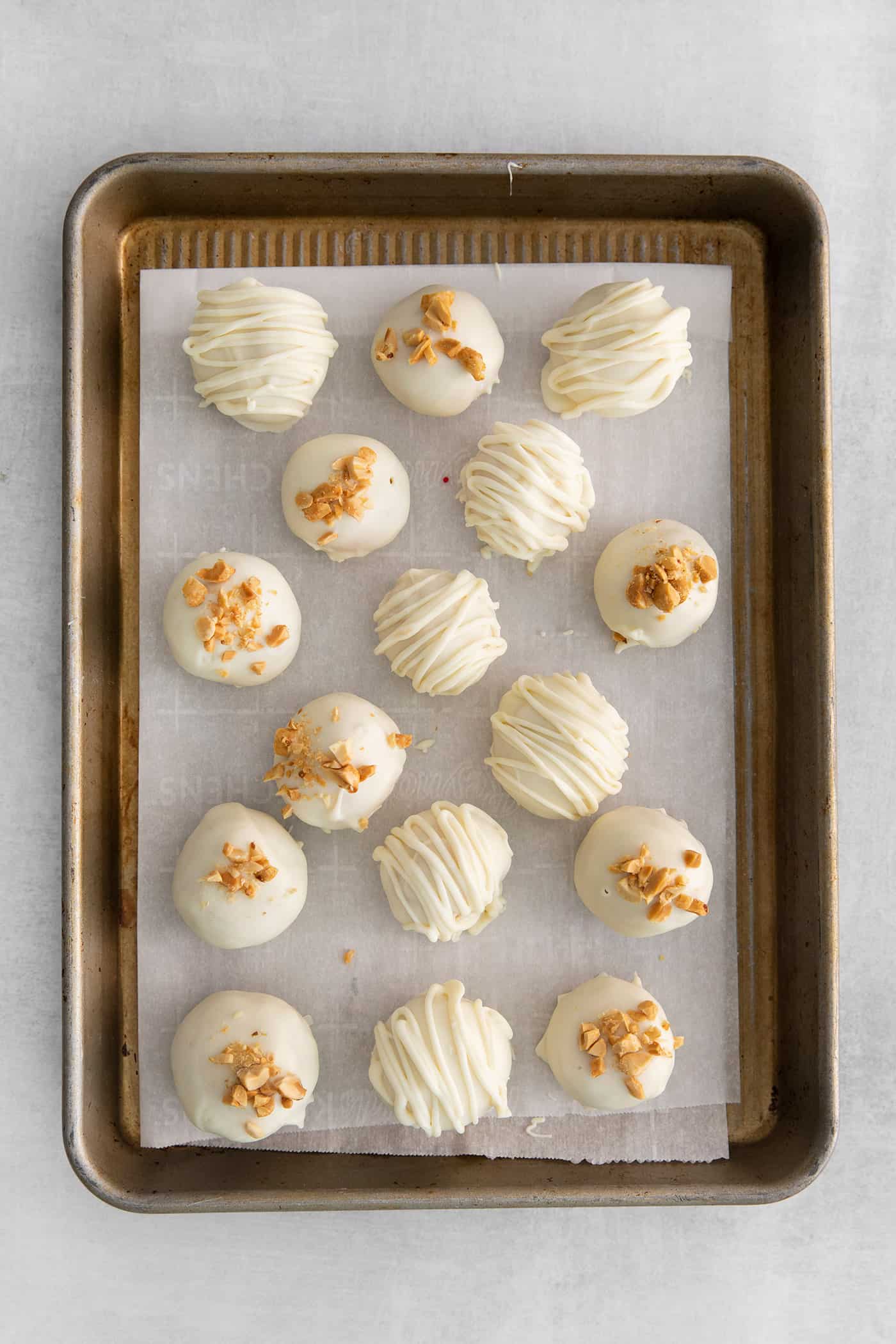 White chocolate peanut butter balls topped with crushed nuts