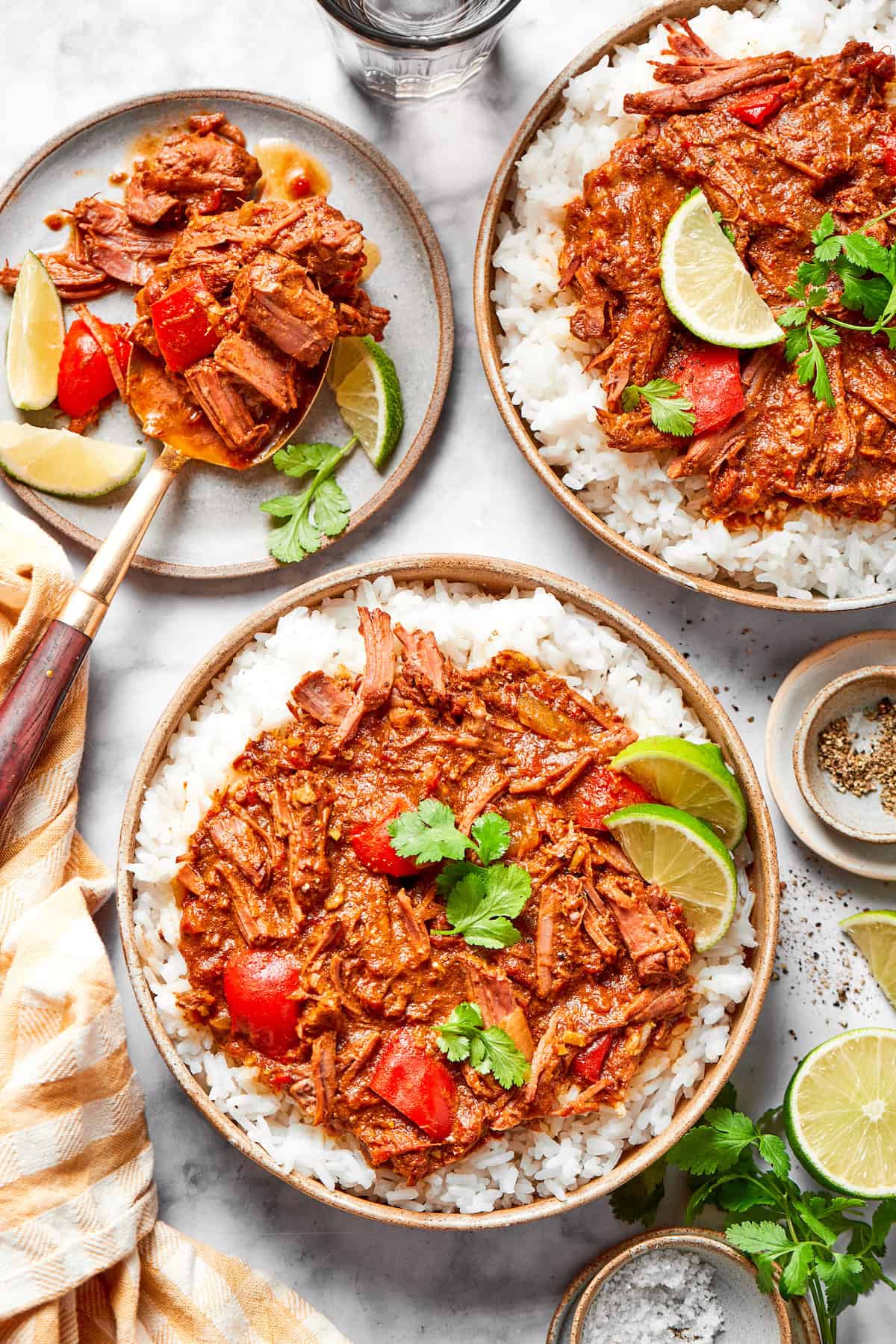 Overhead view of slow cooker beef curry served in bowl with rice