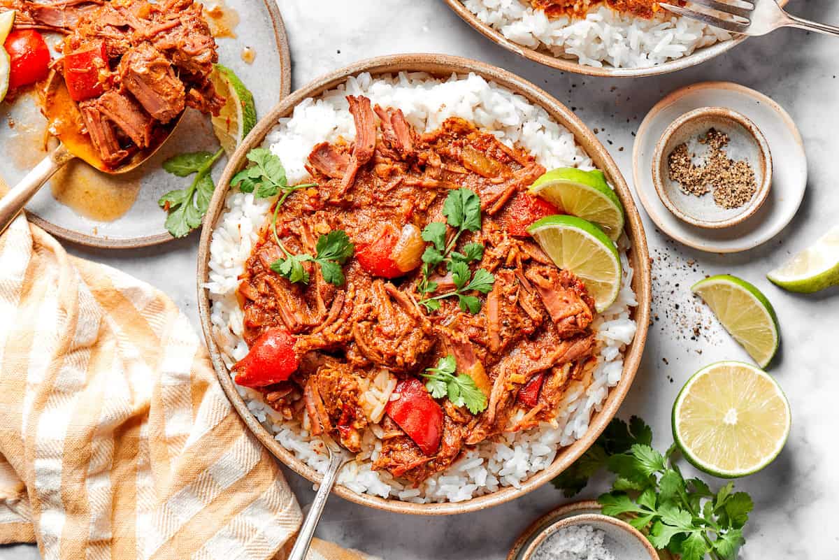 Overhead view of slow cooker beef curry served in bowl with rice