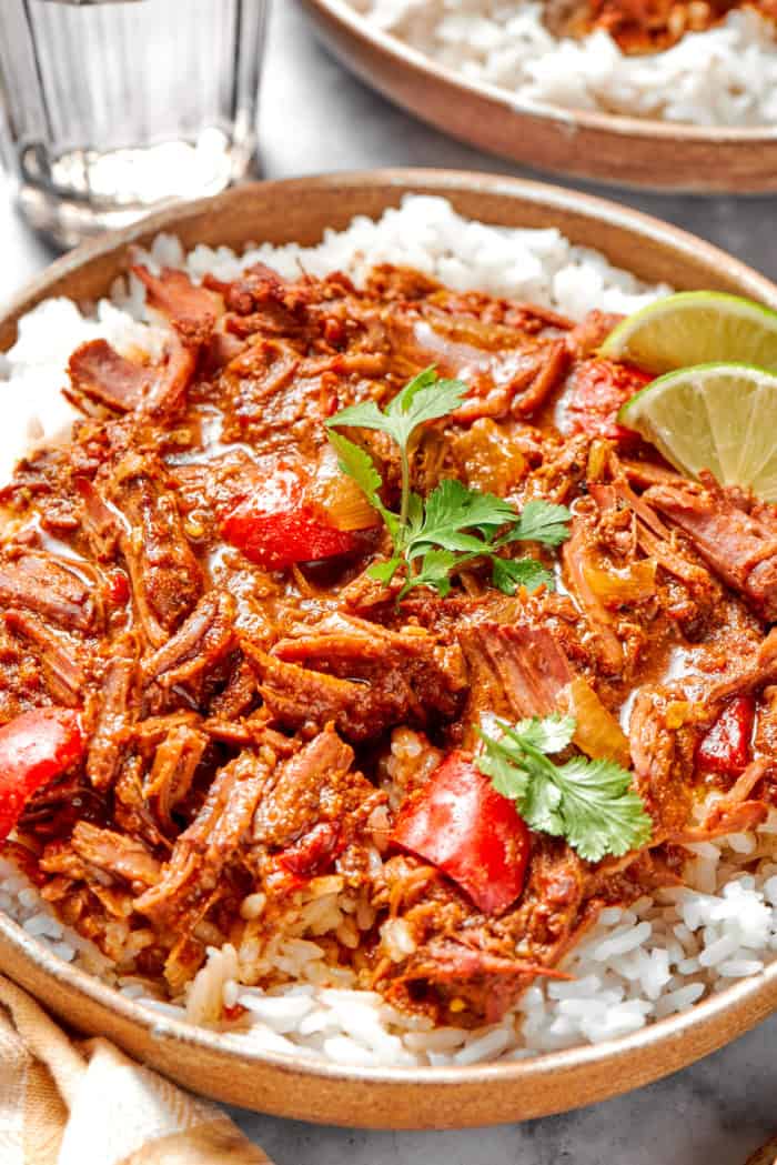 Slow cooker beef curry served over rice in bowl
