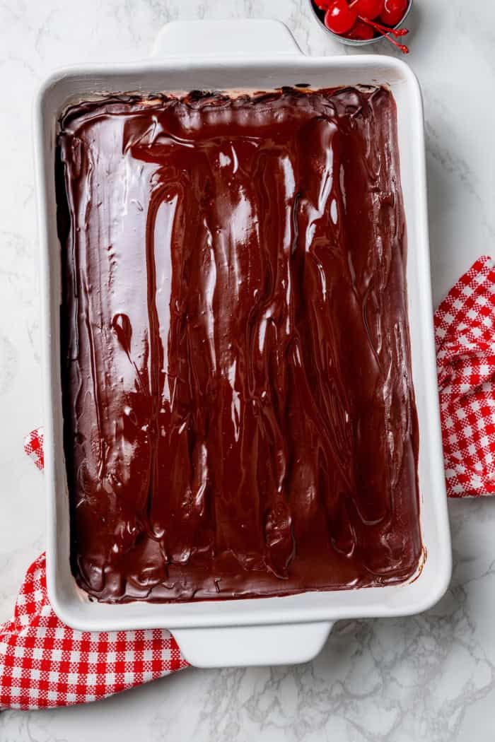 Chocolate glaze added to pan of cherry brownies.