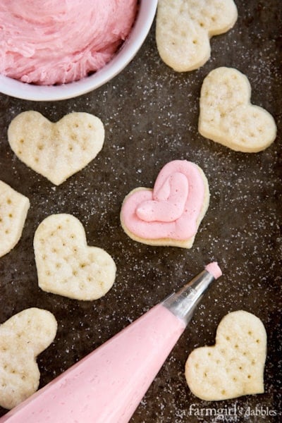 putting frosting on a cookie