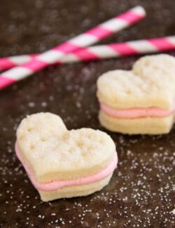 Heart-shaped sandwich cookies with strawberry buttercream filling