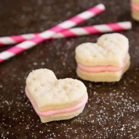 Heart-shaped sandwich cookies with strawberry buttercream filling