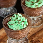 glass dishes of chocolate pudding topped with mint buttercream